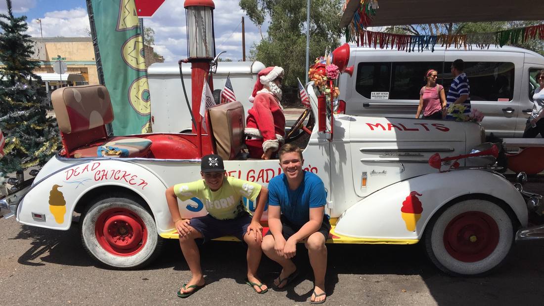Twee jongens bij een oude auto aan Route 66 in Seligman, Arizona, Amerika