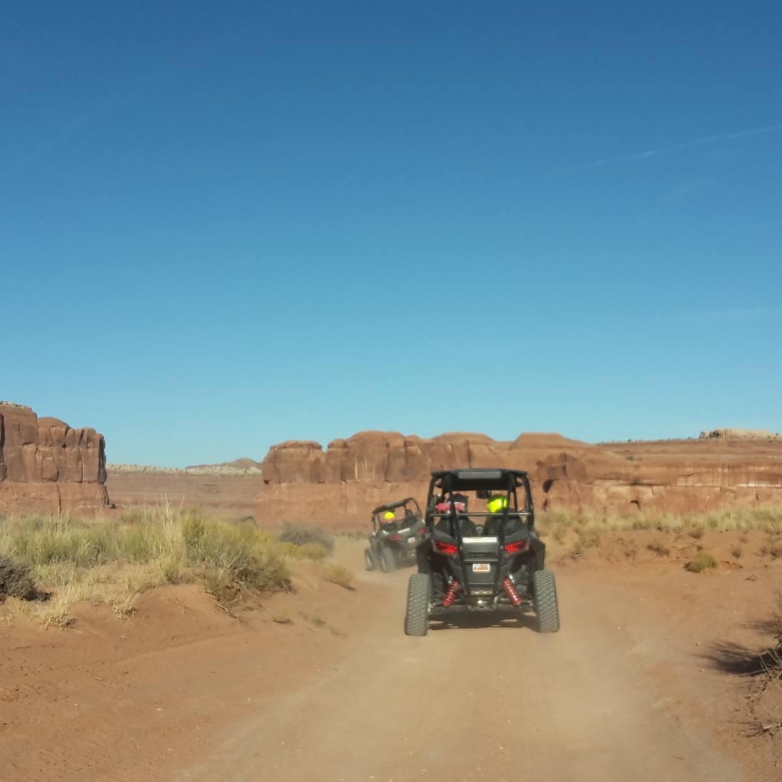 Met de buggy over een zandpad tussen de rotsen bij Moab, Utah, Amerika