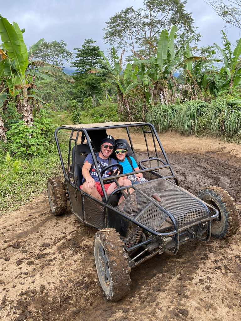 Tieners rijden met een buggy over een modderpad bij Munduk op Bali, Indonesië