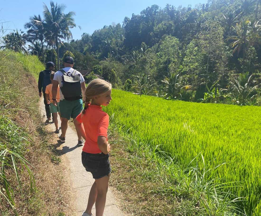 Achter de gids aan over de paden langs de rijstvelden bij Munduk, Bali, Indonesië
