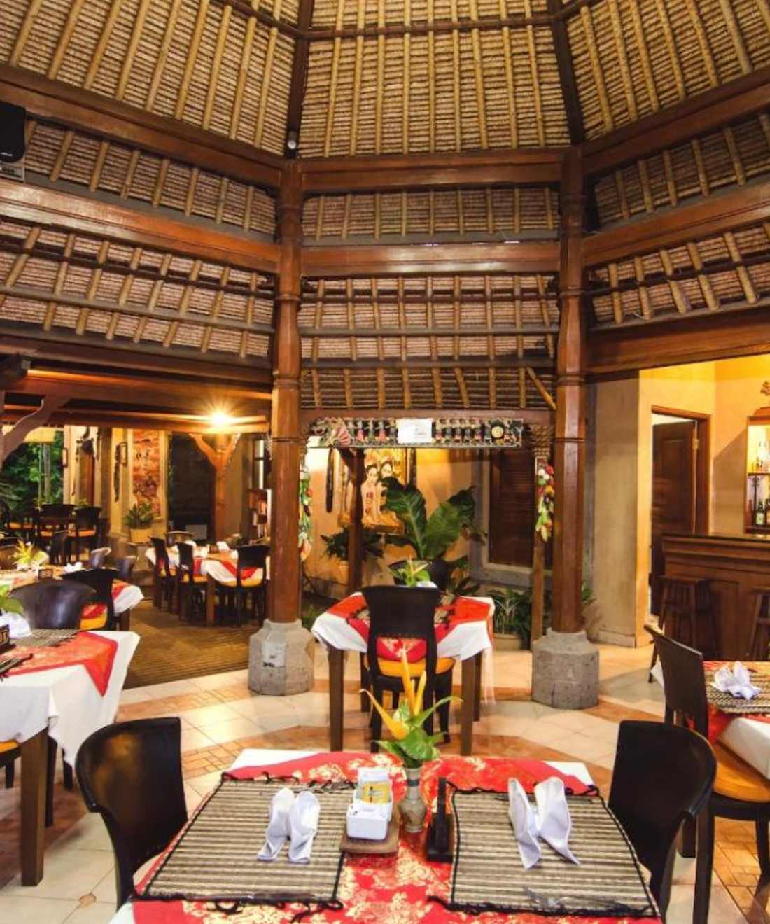 Gedekte tafels in een open paviljoen met rieten dak in Sanur, Bali